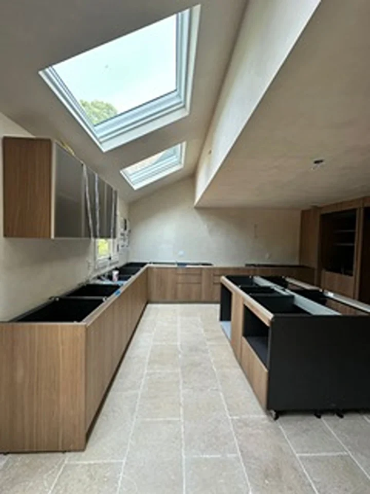 a kitchen with skylights and cabinets