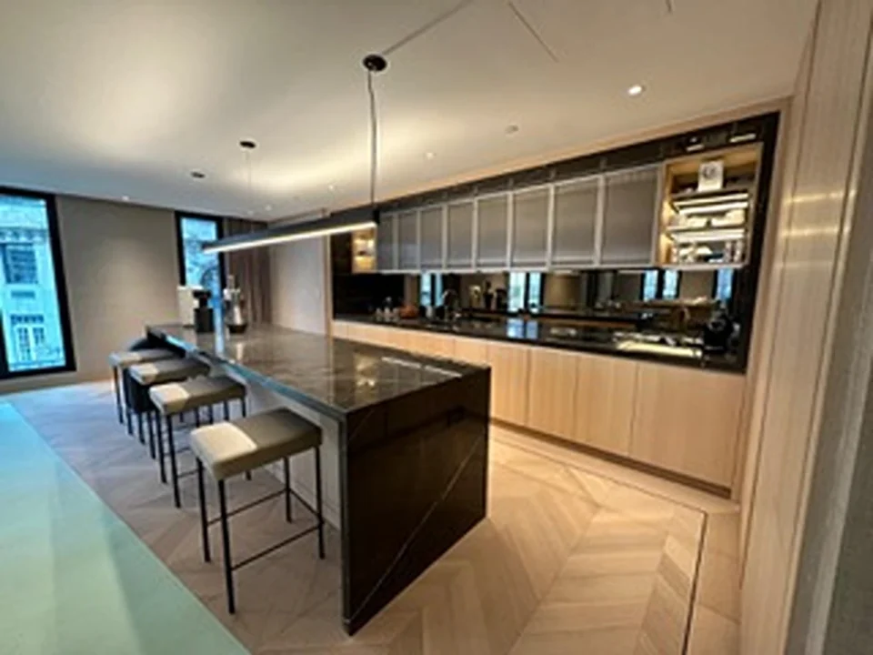 a kitchen with a bar and stools
