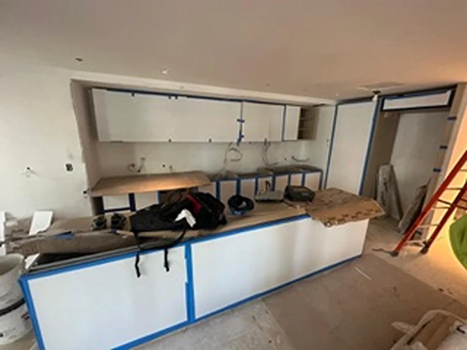 a kitchen with white cabinets and blue trim