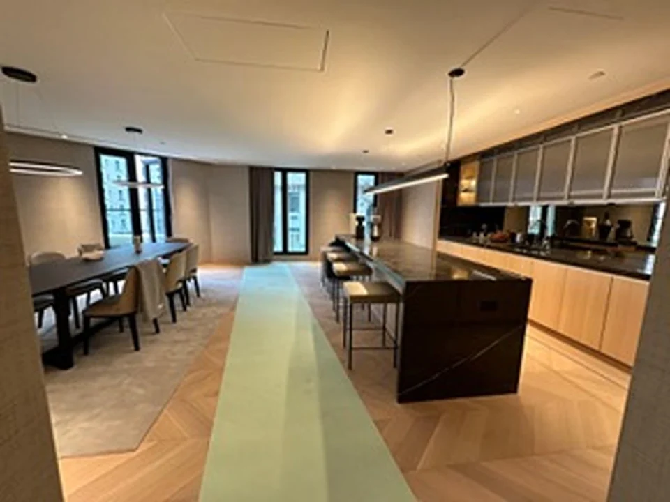 a large kitchen with a long island and a table
