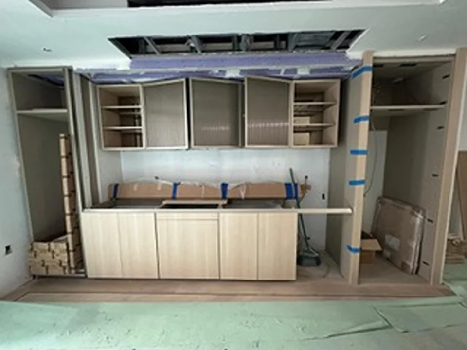 a kitchen under construction with cabinets and shelves