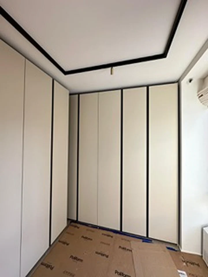 a room with white cabinets and black trim