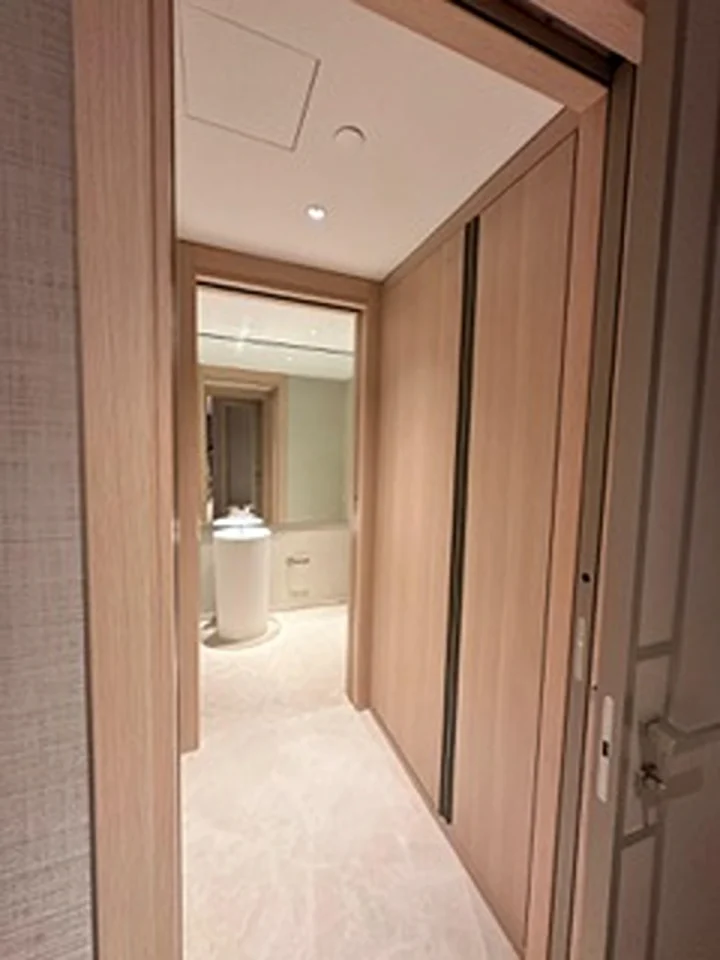 a hallway with a door and a mirror