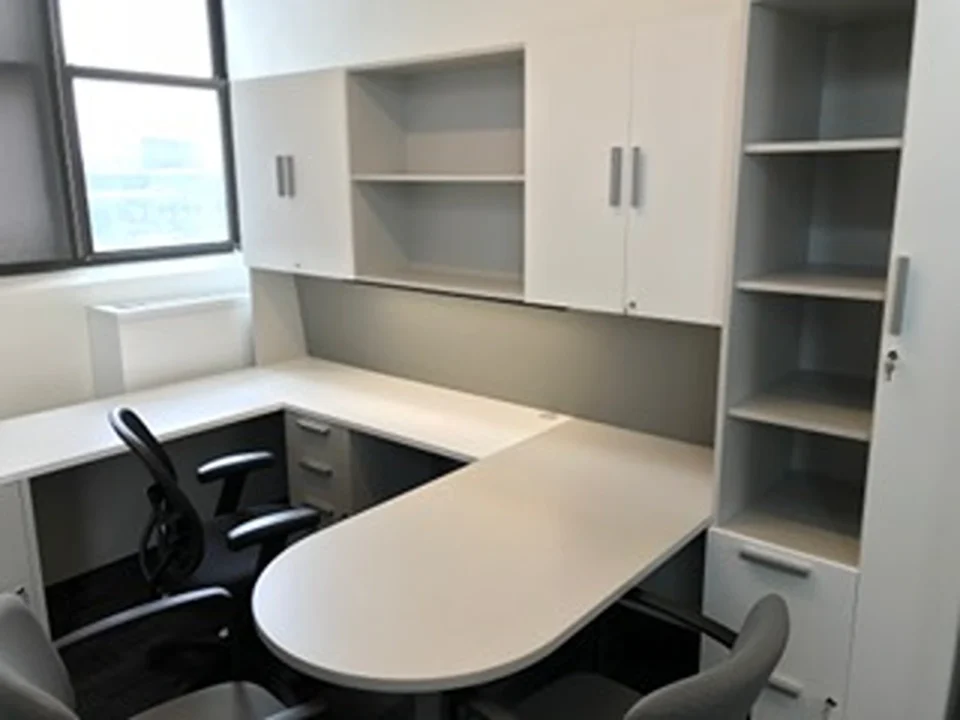 a white office with a desk and chairs