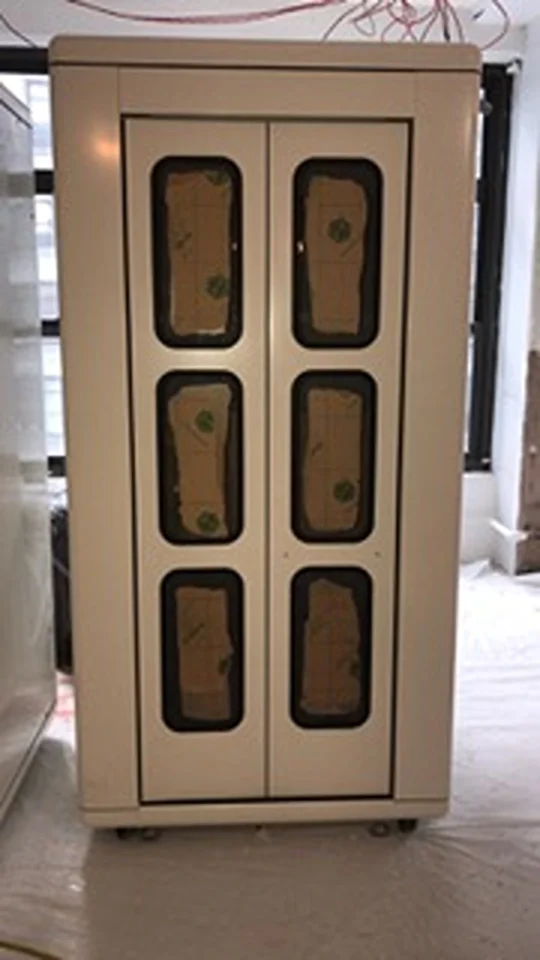 a white cabinet with brown boxes