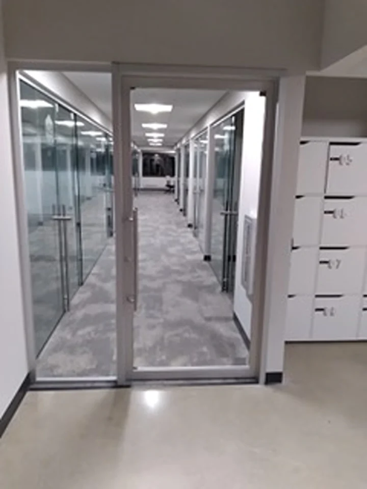 a glass door in a room with the hallway