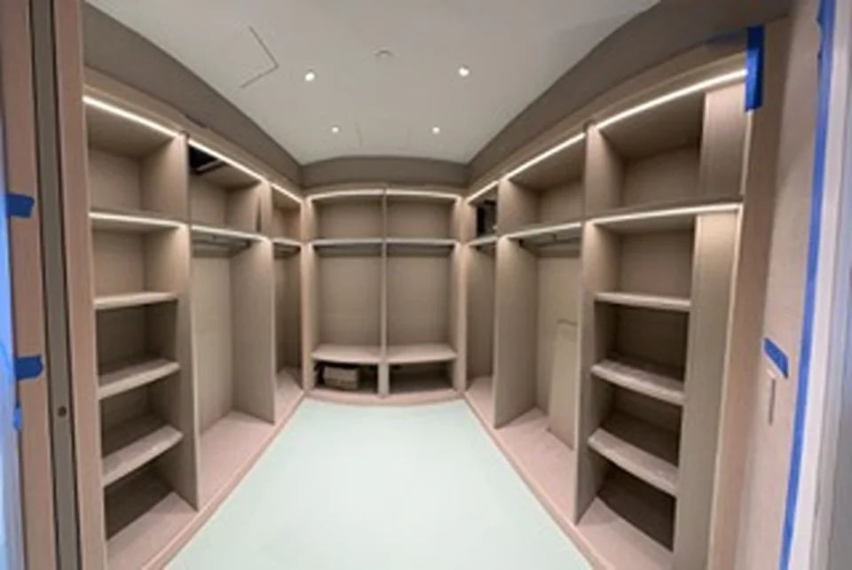a large closet with shelves and lights