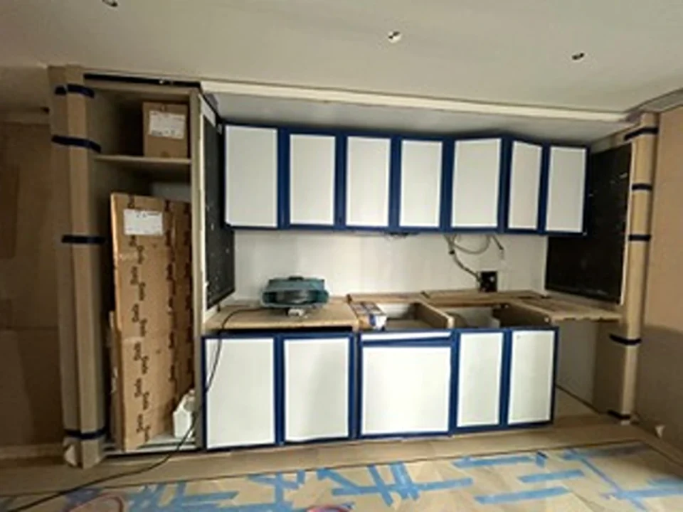 a kitchen with white cabinets and blue trim