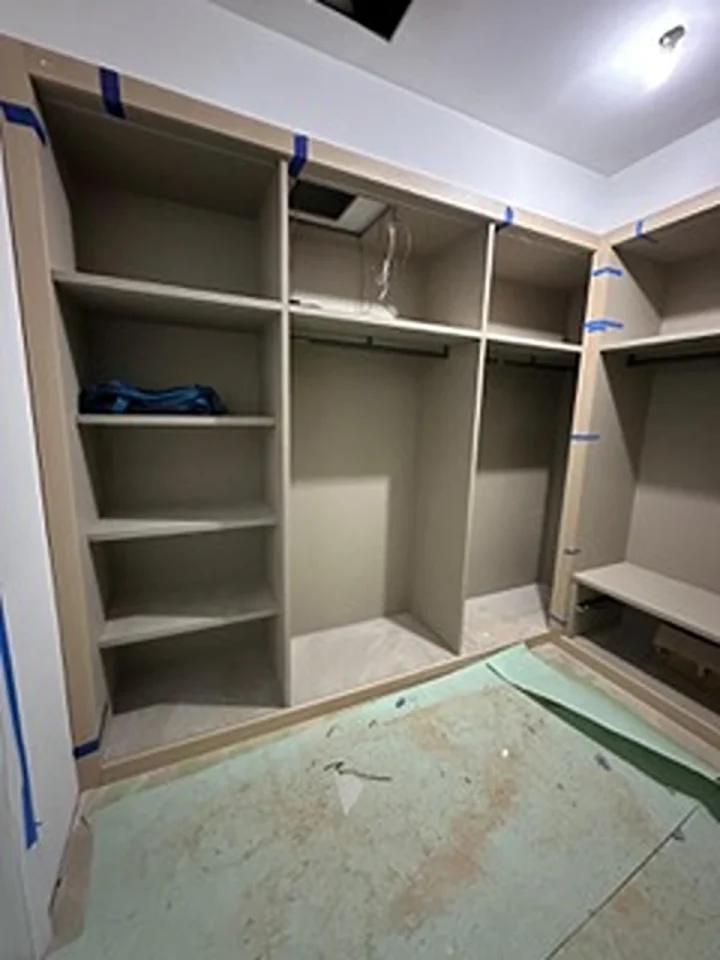 a closet with shelves and a blue bag