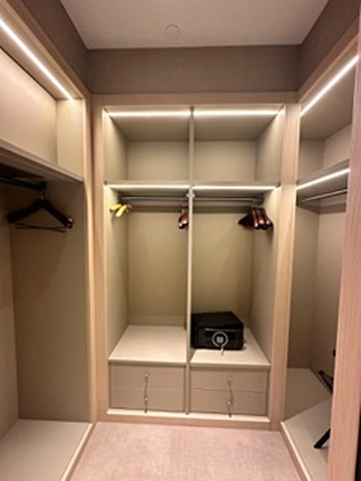 a closet with shelves and lights