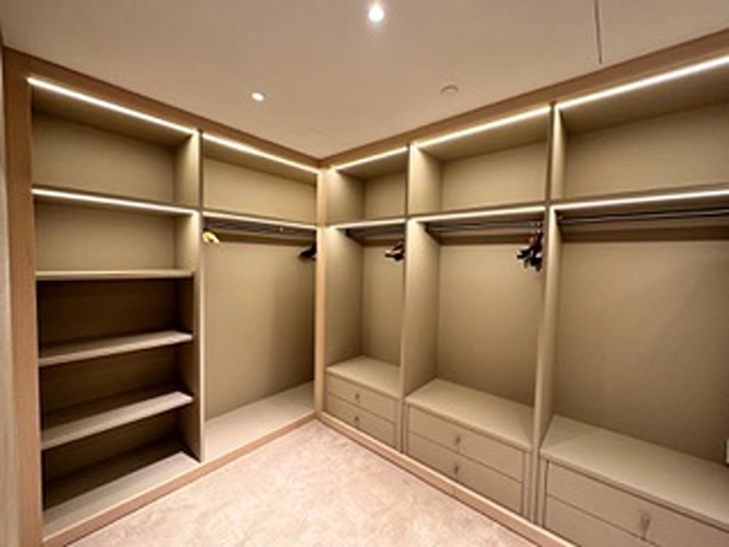 a large closet with shelves and lights
