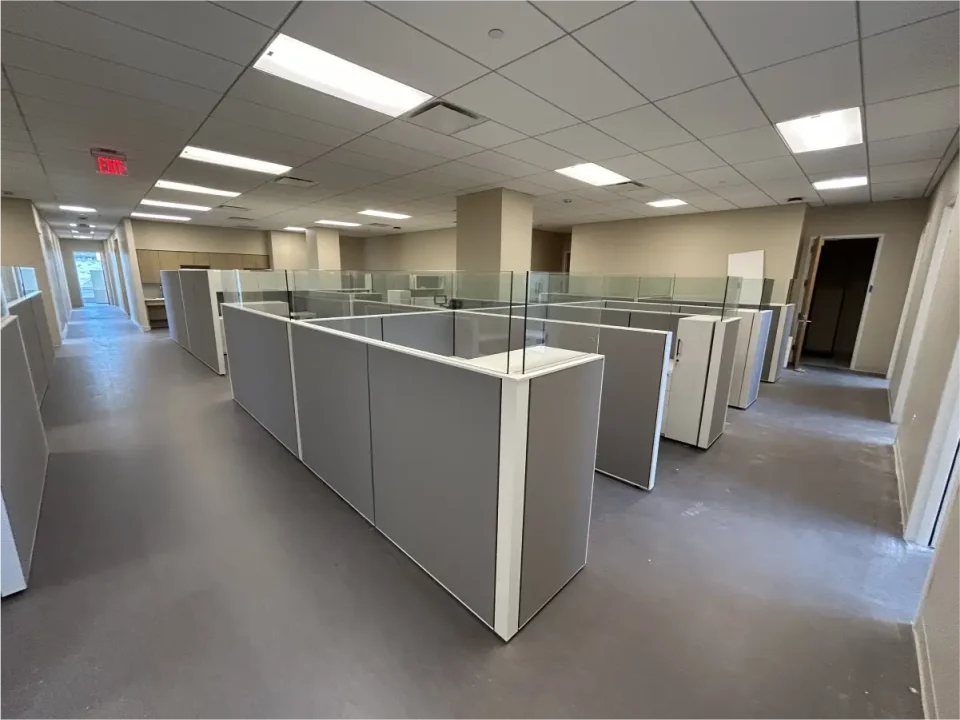 a room with cubicles and a wall