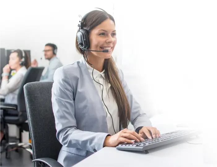 a woman wearing a headset and typing on a keyboard