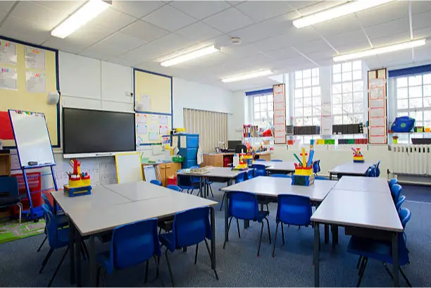 a classroom with tables and chairs