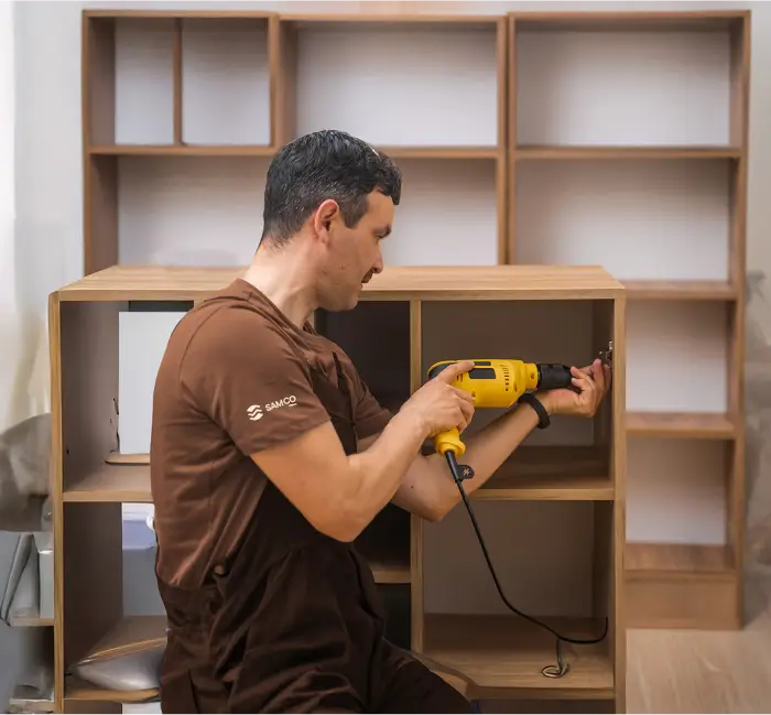 a man holding a yellow drill