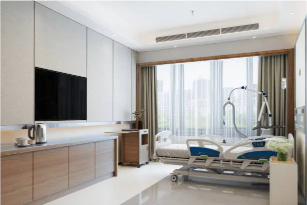 a room with a hospital bed and a tv