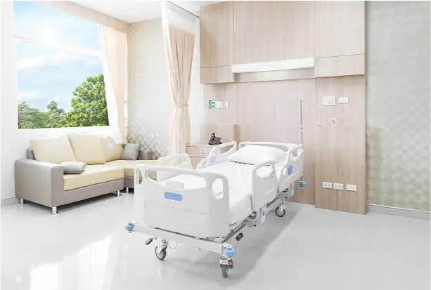 a hospital room with a bed and couch